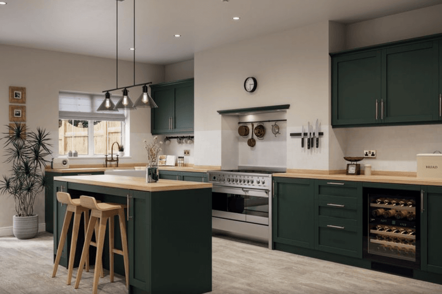 Modern kitchen with green cabinets, island, and stainless steel appliances.